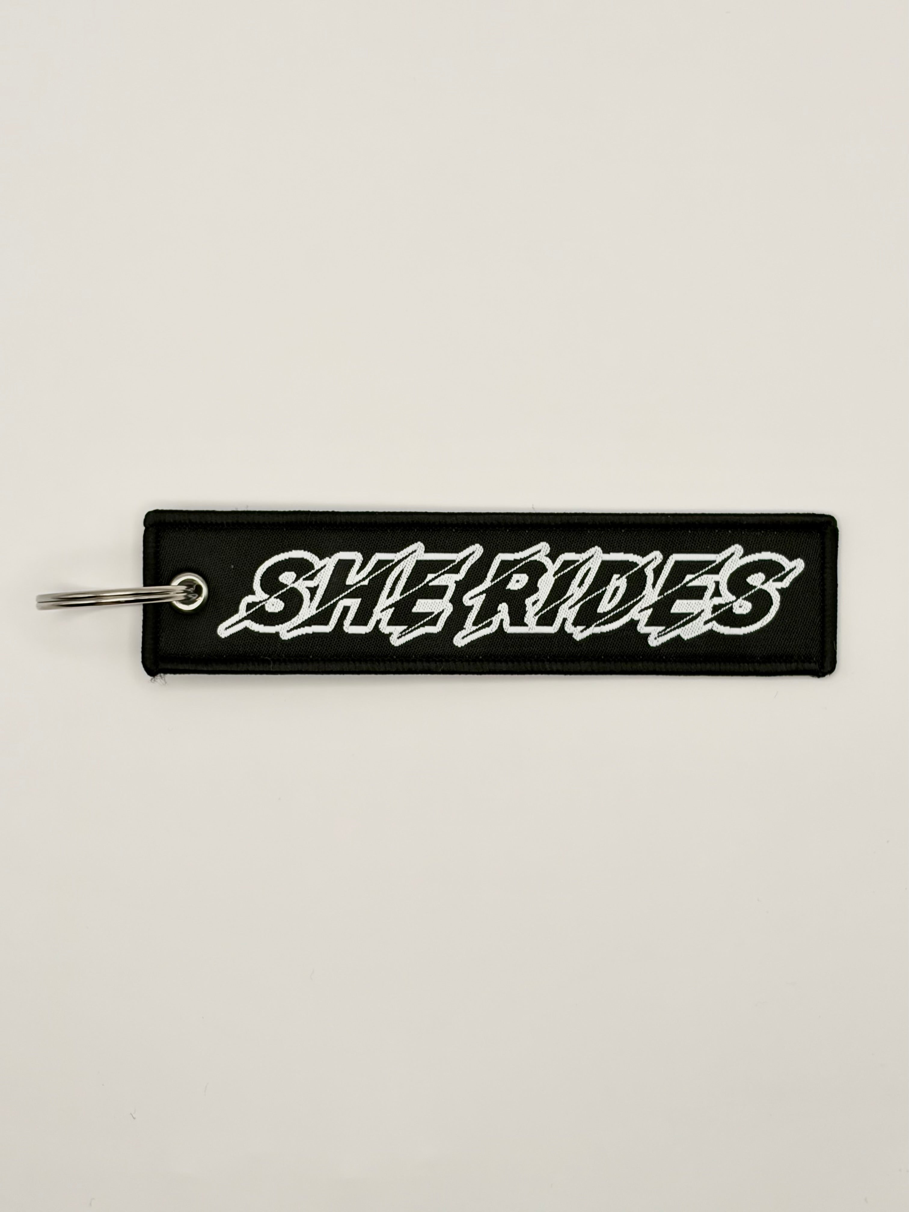 She Rides keychain white