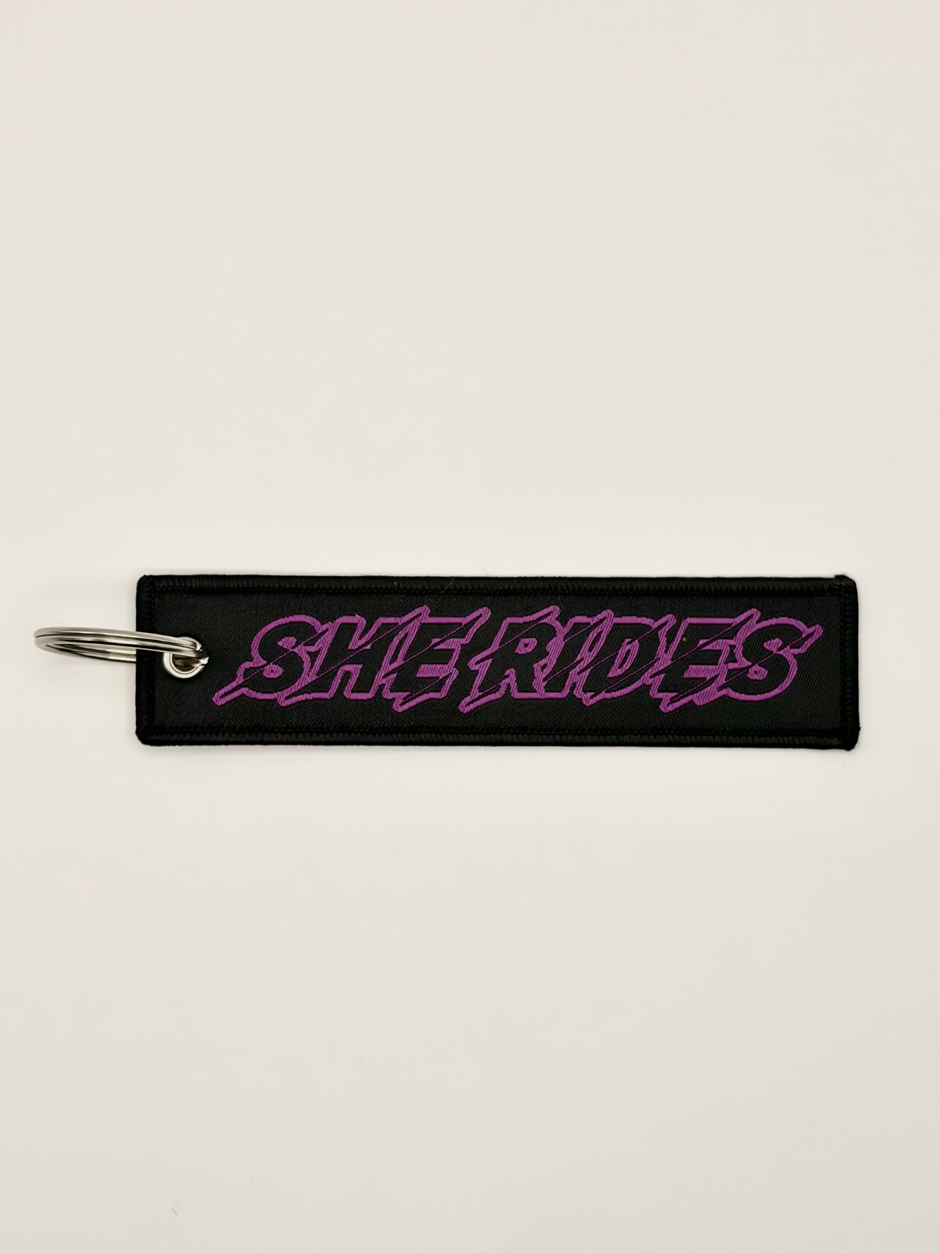 She Rides keychain purple